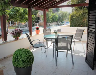a patio with a table and chairs on a patio at Salt Lake Town House in Larnaka