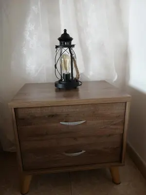 a lamp sitting on top of a wooden dresser at Aprosmeno Jacuzzi House 1 in Agros