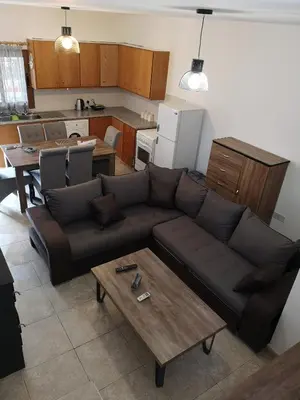a living room with a couch and a table at Aprosmeno Jacuzzi House 1 in Agros