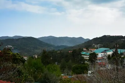 a view of a city with mountains in the background at Aprosmeno Jacuzzi House 1 in Agros