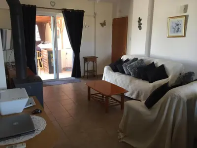 a living room with a couch and a table at 2 Bed Flat - Sleeps 4 - Pool - Parking - Wifi in Xylophaghou
