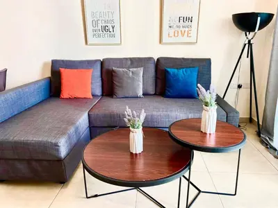 a living room with two tables and a couch at Mythical Sands new Luxury Apartment in Paralimni