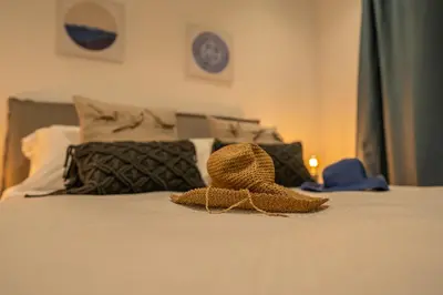 a hat sitting on top of a bed at Andreotis Villas in Protaras