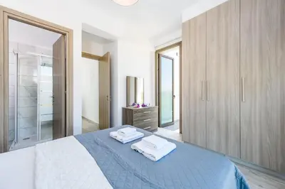 a bedroom with a bed with two towels on it at Levanda #40 in Protaras