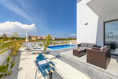 a villa with a swimming pool and a patio at Levanda #40 in Protaras