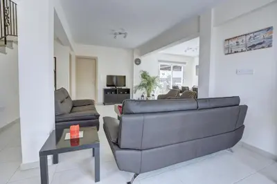 a living room with a couch and a table at Nissi Palms Villa in Ayia Napa