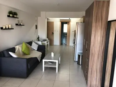 a living room with a couch and a table at Must Stay - City Center in Larnaka