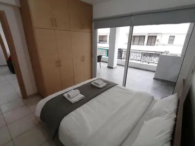a bedroom with a large bed with two towels on it at Must Stay - City Center in Larnaka