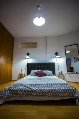 a bedroom with a large bed and a large mirror at Yippee! Apartments I Town Center in Larnaka