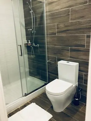 a bathroom with a toilet and a glass shower at White 11 in Larnaka
