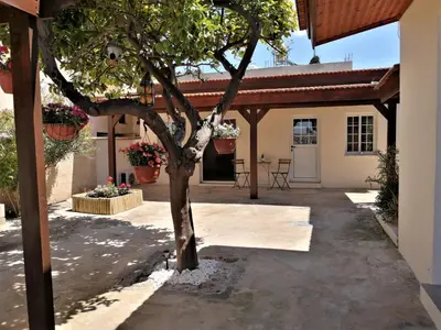 a tree in the courtyard of a house at Lemon Tree Courtyard in Larnaka