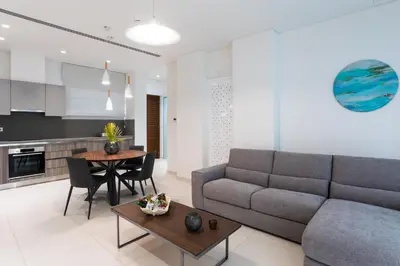 a living room with a couch and a table at NAPA GEM SUITES by LUXEL VILLAS in Ayia Napa