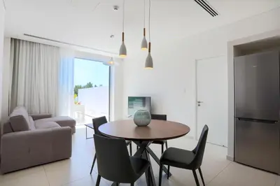 a kitchen and dining room with a table and chairs at NAPA GEM SUITES by LUXEL VILLAS in Ayia Napa