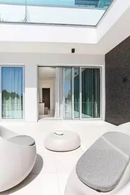 a living room with white furniture and large windows at NAPA GEM SUITES by LUXEL VILLAS in Ayia Napa