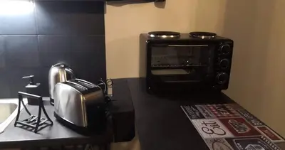 a kitchen with a toaster oven on a counter at The room in Larnaka