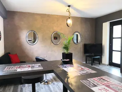 a living room with a table and chairs and mirrors at The room in Larnaka