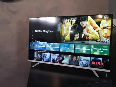 a flat screen tv on a stand with movies at The room in Larnaka
