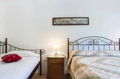 a bedroom with two beds and a table with a lamp at Aunt Maria's in Pano Lefkara