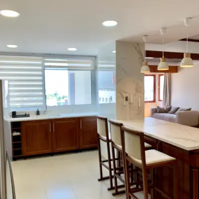 a kitchen with a table and chairs and a couch at Modern 2 bed room large apartment in Nicosia