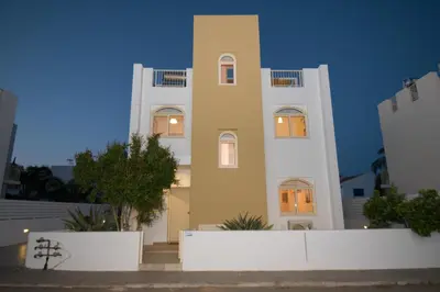 a tall white building with lights on at Villa Pomelo in Protaras