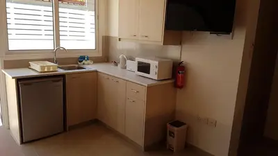 a small kitchen with a sink and a microwave at ZORBAS No 3 in Larnaka