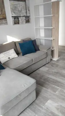 a living room with a gray couch and blue pillows at Aquamarine in Voroklini