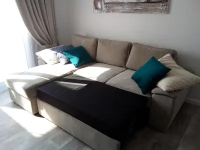 a couch with blue pillows in a living room at Aquamarine in Voroklini
