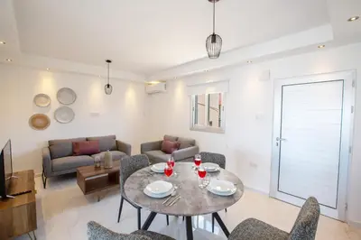a living room with a table and chairs at Rio Luxury Apartment in Ayia Napa
