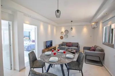 a living room with a table and chairs at Rio Luxury Apartment in Ayia Napa