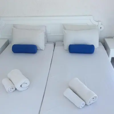 a bed with towels and pillows on a boat at Aphentrika Apartments in Protaras