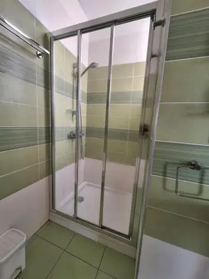 a shower with a glass door in a bathroom at Limassol sea view studio in Limassol