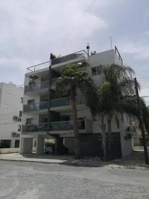 a tall building with palm trees in front of it at Fine Designed Flat 302 in Larnaka