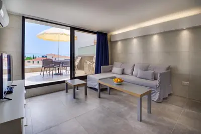 a living room with a couch and a table at Gevoni Deluxe Suites in Ayia Napa