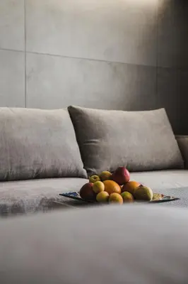 a plate of fruit on top of a couch at Gevoni Deluxe Suites in Ayia Napa