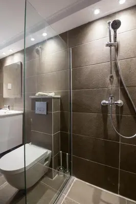 a bathroom with a shower with a toilet and a sink at Gevoni Deluxe Suites in Ayia Napa