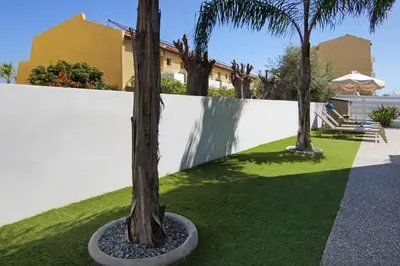a group of palm trees in a yard at Villa Megan in Protaras