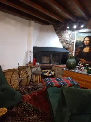 a living room with a couch and a fireplace at Madari Hills Health Retreat in Nicosia