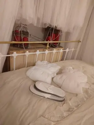 a bed with white pillows and a phone on it at Madari Hills Health Retreat in Nicosia