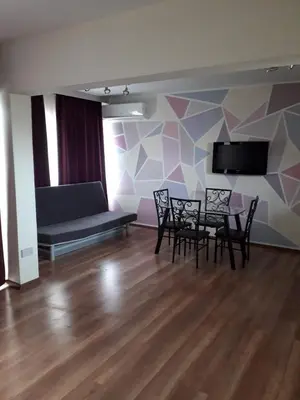 a room with chairs and a couch and a tv at 1bd next to Dasudi in Limassol