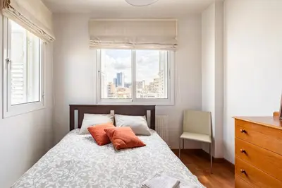 a bedroom with a bed with two pillows and a window at Warm Residence in the heart of the City Center - Balcony & view in Nicosia