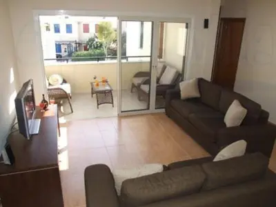 a living room with a couch and a room with a balcony at Ocean View sunny retreat in Protaras