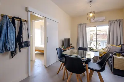 a living room with a table and chairs at The Joy - Centre One Bedroom Flat in Larnaka