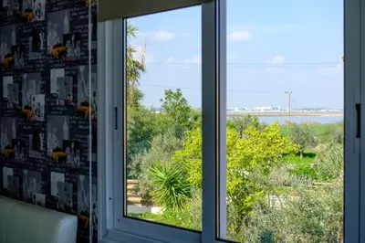 a window with a view of the ocean at Demetris apartment in Meneou