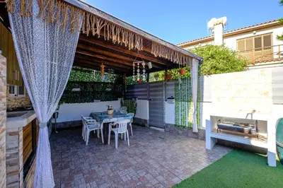 a patio with a table and chairs on it at Demetris apartment in Meneou