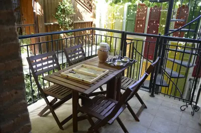 a wooden table and chairs on a balcony at Crambero Suites in Alona