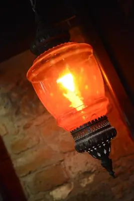 an orange light is hanging from a pole at Crambero Suites in Alona