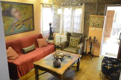 a living room with a couch and two chairs and a table at Crambero Suites in Alona