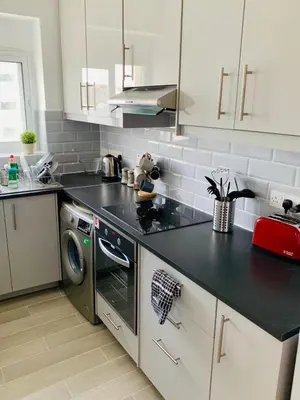 a kitchen with a black counter top and a dishwasher at Thalassa Sea View Suite in Limassol
