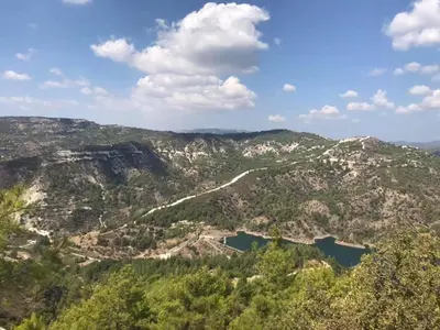 an aerial view of a mountain valley with a lake at Salamiou Stone House in Paphos City