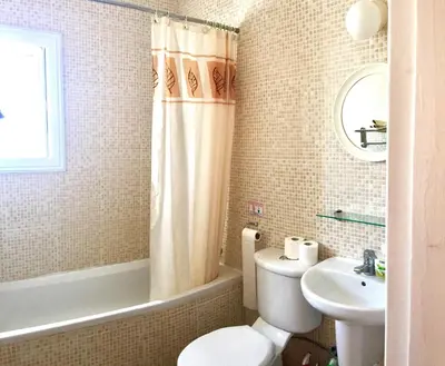 a bathroom with a toilet and a sink and a tub at Villa Lola in Ayia Napa